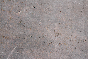 The texture of a natural gray stone with golden impregnations. Copy space stone background.