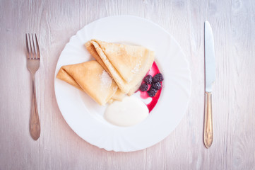 Pancakes with blackberry and sour cream