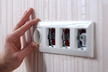 Wall power sockets installation. Man installing group of electrical outlets and TV Antenna outlet socket