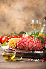 Ingredients for spaghetti Bolognaise or Bolognese with savory minced beef and tomato, basil and spices. Italian healthy food concept with copy space.