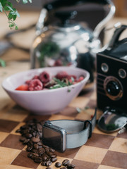 Smartwatch on coffee table with retro camera in background