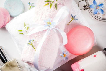Spa relax and bath concept, sea salt, soap, with cosmetics and towels in bathroom white background, copy space