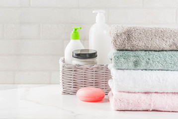 Spa relax and bath concept, sea salt, soap, with cosmetics and towels in bathroom white background, copy space top view