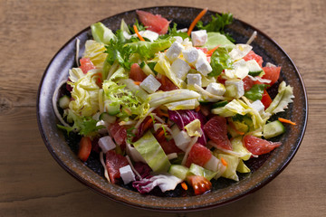Grapefruit, tomato, lettuce and cucumber salad with feta cheese. Clean eating, healthy and diet food concept
