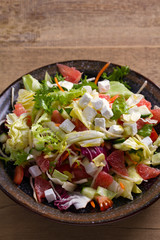 Grapefruit, tomato, lettuce and cucumber salad with feta cheese. Clean eating, healthy and diet food concept