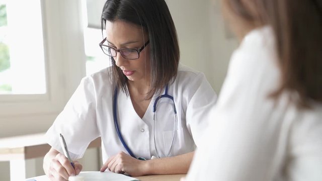 Doctor prescribing medication to patient 