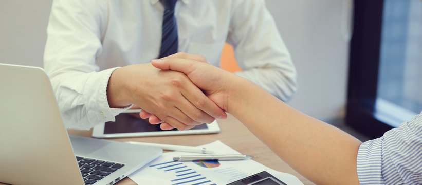 close up business man handshake with parrtner concept