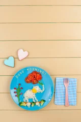 Fotobehang Funny elephant with ballons from rice and fresh vegetables on wooden background © lithiumphoto
