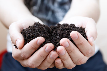 Man farmer holding soil. Earth day and ecology concept