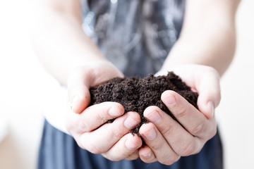 Man farmer holding soil. Earth day and ecology concept