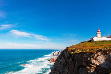 Fototapeta na wymiar Scenic landscape with lighthouse at the Cabo da Roca, a cape which forms the westernmost extent of mainland Portugal.