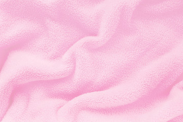 Fluffy Gentle baby pink fabric with waves and folds. Soft pastel textile texture. Folds on the soft...