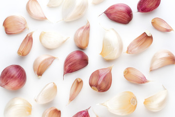 Onion and garlic isolated on white background, top view. Wallpaper abstract composition of vegetables.