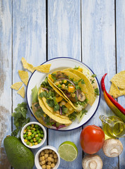 vegetable tacos on blue wooden surface