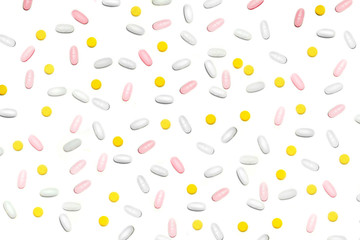a lot of multicolored pills and tablets on the white background.