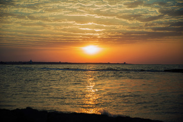Fototapeta premium Beautiful summer golden sunset above the black sea.with calm waves and reflection of sun on the beach.Azerbaijan nature