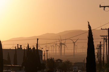 California Windmills in urban setting surrounded by mountains