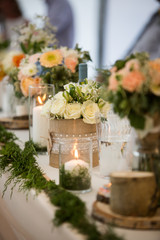 Candles and flower bouquets at a wedding reception