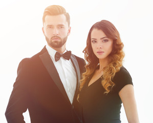 Portrait of a handsome man looking at the camera with a woman