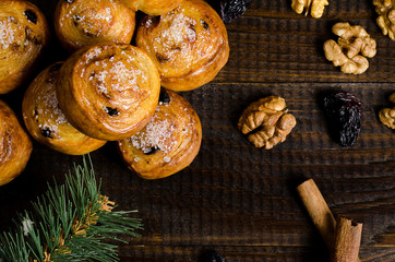 homemade cookies with sugar and walnuts, on a dark wooden background with a spruce branch