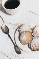 Homemade french madeleines with beurre noisette on white wooden table