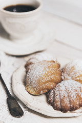 Homemade french madeleines with beurre noisette on white wooden table