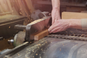 Carpenter Working on Woodworking Machines in Carpentry Shop. Male Hand Close up.