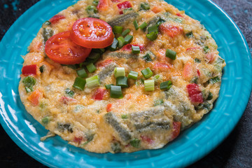 Omelet, fried chicken eggs with fresh vegetables