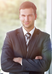 successful businessman standing near window in office.