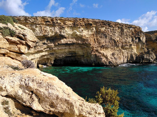 Comino island blue lagoon. Malta blue turquoise sea water beach. Rock and cliff sunny seashore. Travel mediterranean.
