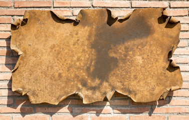 antique rusty metallic billboard on a brick wall