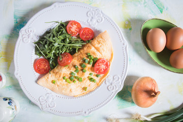 Omelet, fried chicken eggs with fresh vegetables