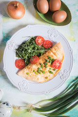 Omelet, fried chicken eggs with fresh vegetables