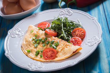Omelet, fried chicken eggs with fresh vegetables