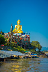 Beautiful outdoor view of golden budha located at golden triangle Laos