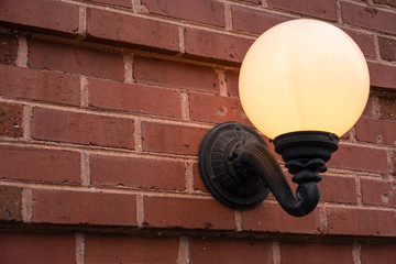 globe light on brick wall illuminated warm glow