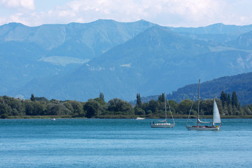 Fototapeta na wymiar Sailboats on the Lake of Constance in front of Alps. 