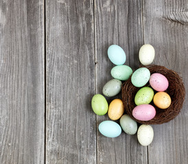Colorful eggs on vintage wooden planks for Easter Background