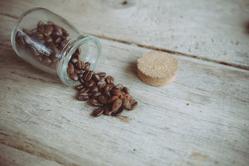 Coffee beans in old  glass bottle