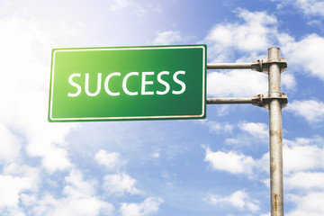 Success Road Sign Against Blue Sky