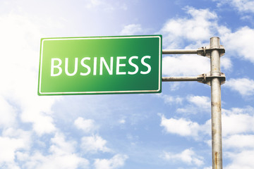 Business Road Sign Against Blue Sky