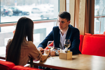 Happy young couple taking selfie with smart phone at cafe