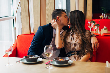 Happy young couple taking selfie with smart phone at cafe