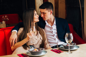 Happy young couple taking selfie with smart phone at cafe