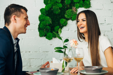 Happy young couple taking selfie with smart phone at cafe