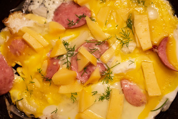 Scrambled eggs with dill cheese and sausage sliced