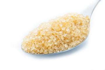 brown sugar in a spoon on white background