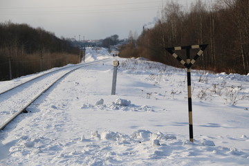 railway in winter. Rails and sleepers - a road for locomotives and electric locomotive covered with...