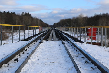 railway in winter. Rails and sleepers - a road for locomotives and electric locomotive covered with snow.