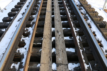 railway in winter. Rails and sleepers - a road for locomotives and electric locomotive covered with snow.
